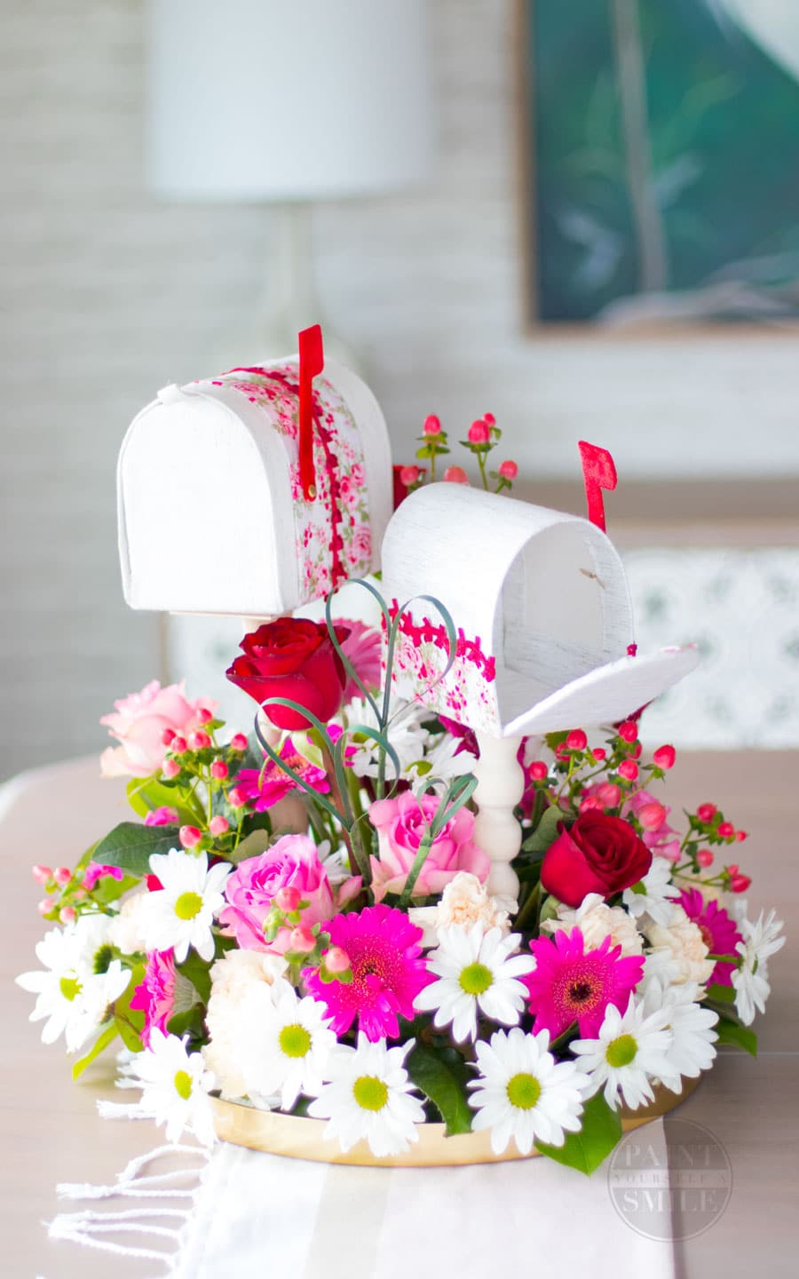 Easy DIY Valentine's Mailboxes made from fabric, cardboard, and wooden candle sticks.