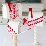 Easy DIY Valentines Mailboxes made from fabric, cardboard, and wooden candle sticks.