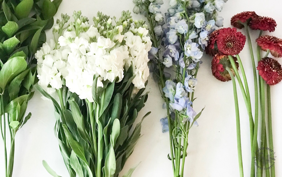 Patriotic flowers: red gerber daisies, white, and blue delphinium