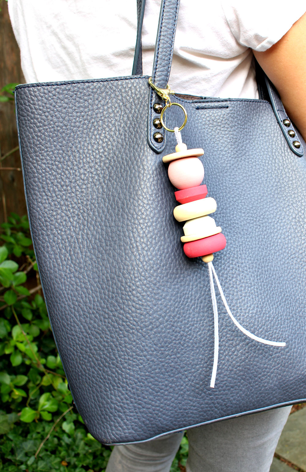 painted wood and leather purse bag tassel