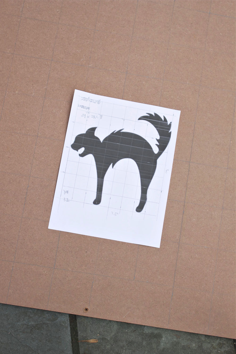 A DIY tutorial to create a large black cat silhouette cut out from wood. Make a statement with a big black cat as part of your Halloween decor. enlarging a shape using grid method