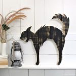large black cat wood cut out on ledge
