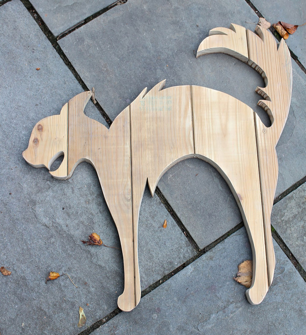 A DIY tutorial to create a large black cat silhouette cut out from wood. Make a statement with a big black cat as part of your Halloween decor. cat shape wood cut out