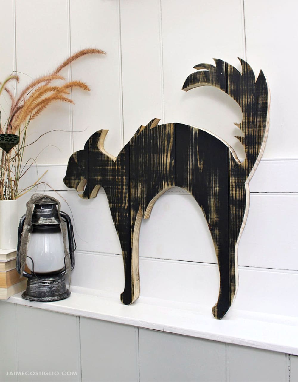 A DIY tutorial to create a large black cat silhouette cut out from wood. Make a statement with a big black cat as part of your Halloween decor. DIY black cat wood cut out silhouette