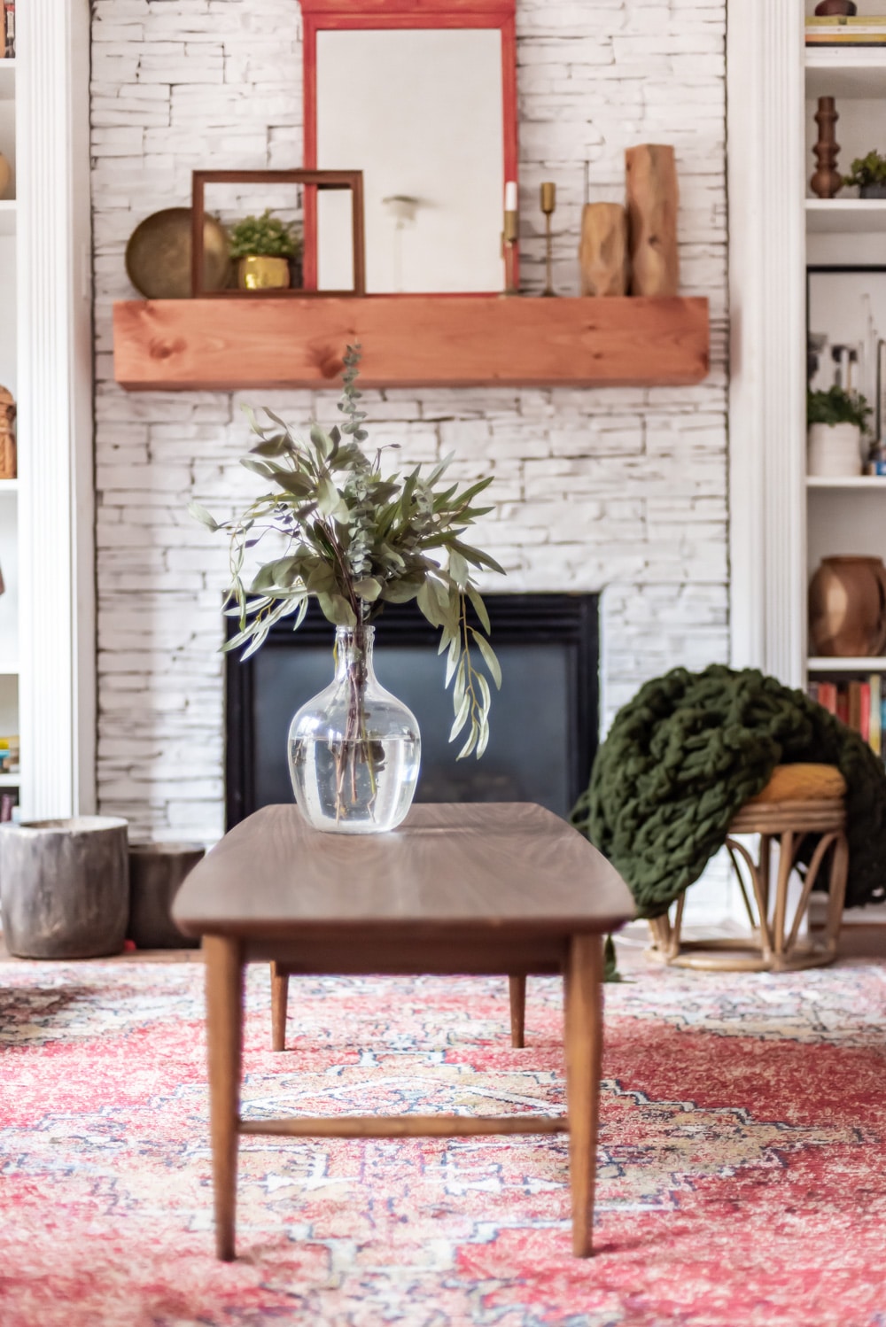 fresh branches displayed in glass was on coffee table