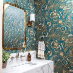 Gorgeous powder room renovation featuring a floating stone vanity and statement wallpaper