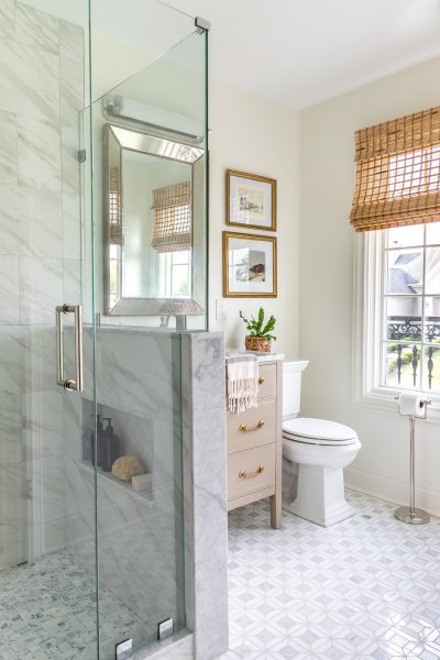 Stunning guest bathroom renovation featuring marble mosaic tile and vintage accents