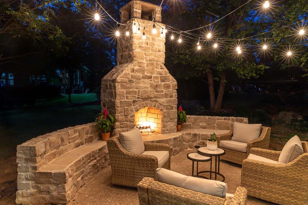 Beautiful patio space featuring an outdoor fireplace with bench seating