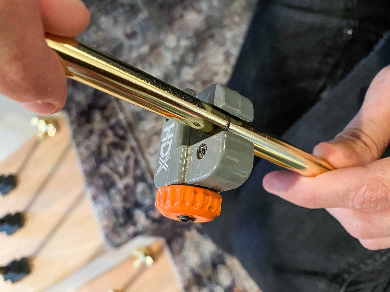 Cutting brass stair rods to length with a pipe cutter