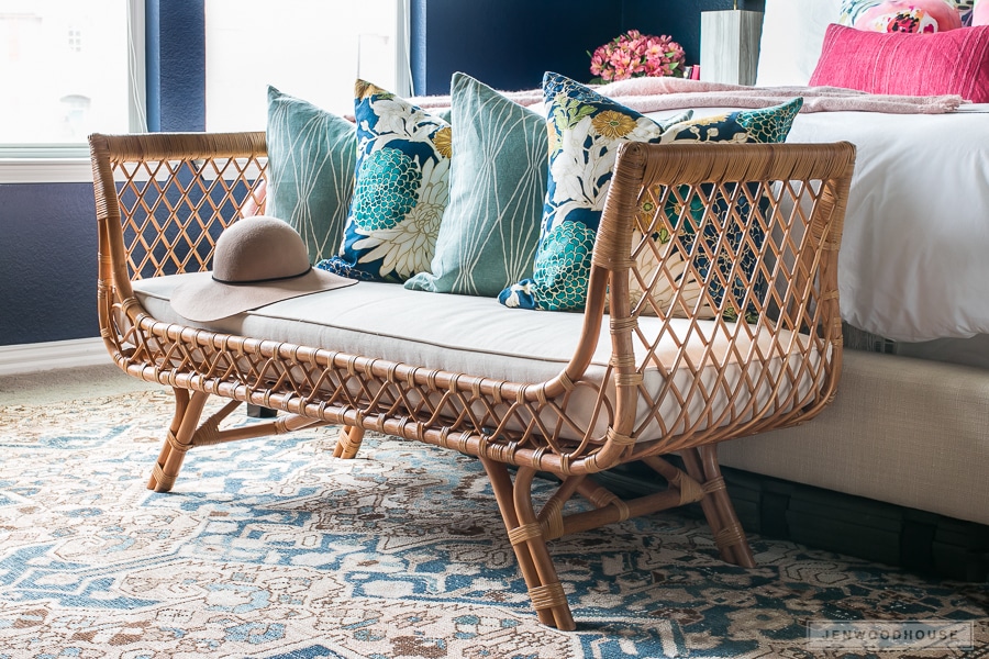 Absolutely love this rattan bench at the end of the bed